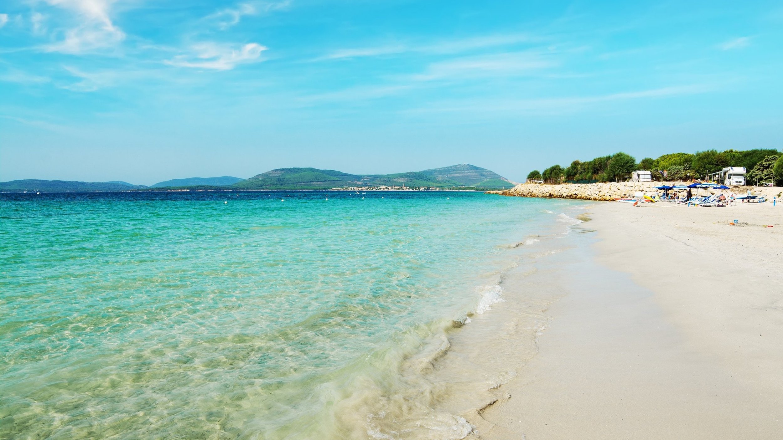 Pristine Alghero beach with turquoise Mediterranean waters and white sand in Sardinia